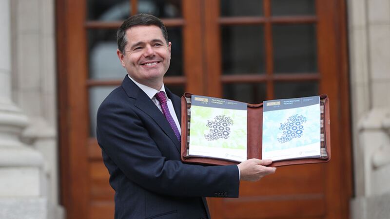Finance Minister Paschal Donohoe holds his tax and expenditure reports outside Government buildings in Dublin before delivering his budget speech&nbsp;