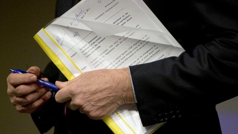 European Union chief Brexit negotiator Michel Barnier with the first draft legal text of the EU&#39;s withdrawal agreement. Picture by AP Photo/Virginia Mayo 