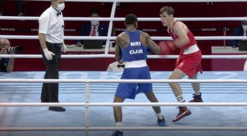 West Belfast boxer Aidan Walsh (red) fights his way to at least a bronze medal for Team Ireland in the Tokyo Olympics 