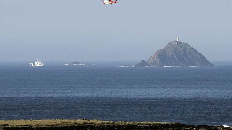 An Irish Coastguard helicopter searching along the coastline near Blacksod, Co. Mayo 