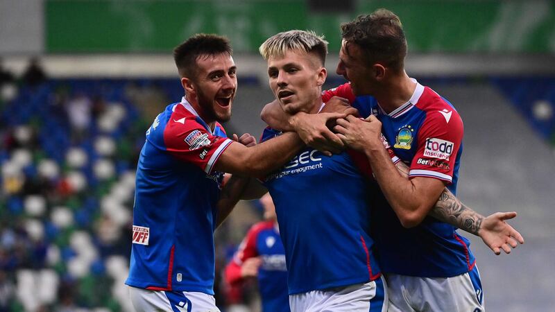 Chris McKee (centre) celebrates with team-mates after scoring his second goal for Linfield