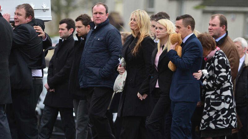 Joshua Kelly&#39;s parents Clare and Michael follow the coffin of their son at his funeral Mass in St Patrick&#39;s Church, Portaferry. Picture by Pacemaker Press 