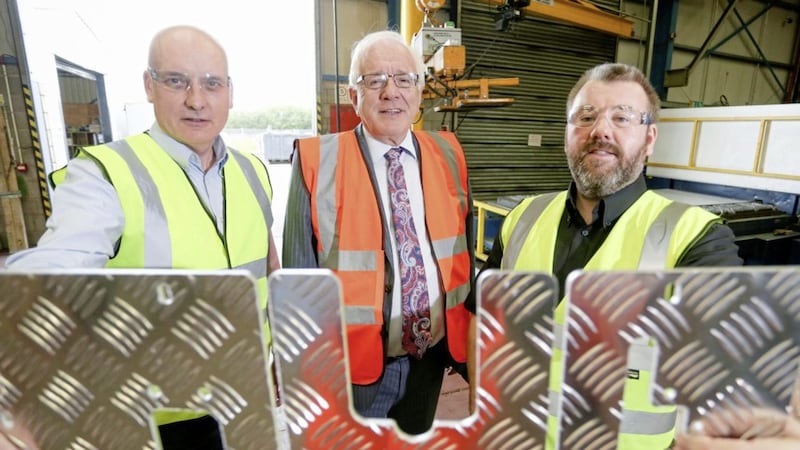KME Steelworks directors Seamus Murchan and Jason Quinn are pictured with the Chairman of Lisburn and Castlereagh City Council&#39;s development committee, Allan Ewart at their Lisburn-based manufacturing site 