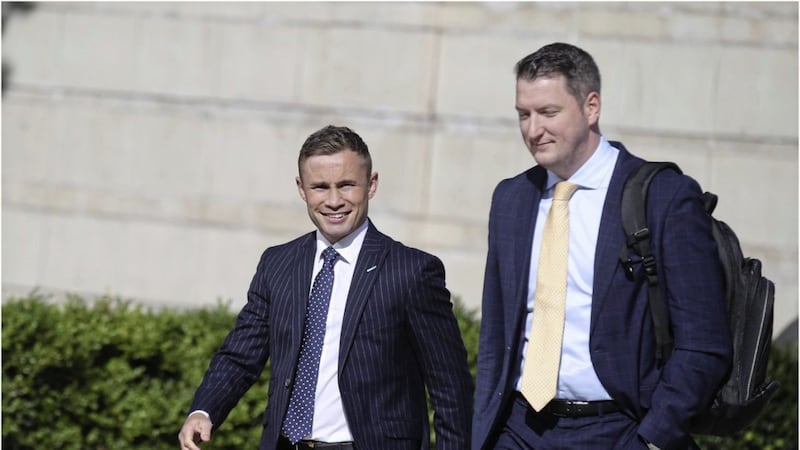 Boxer Carl Frampton attending the High Court earlier this week with solicitor and Sinn F&eacute;in MP John Finucane. Picture by Hugh Russell 