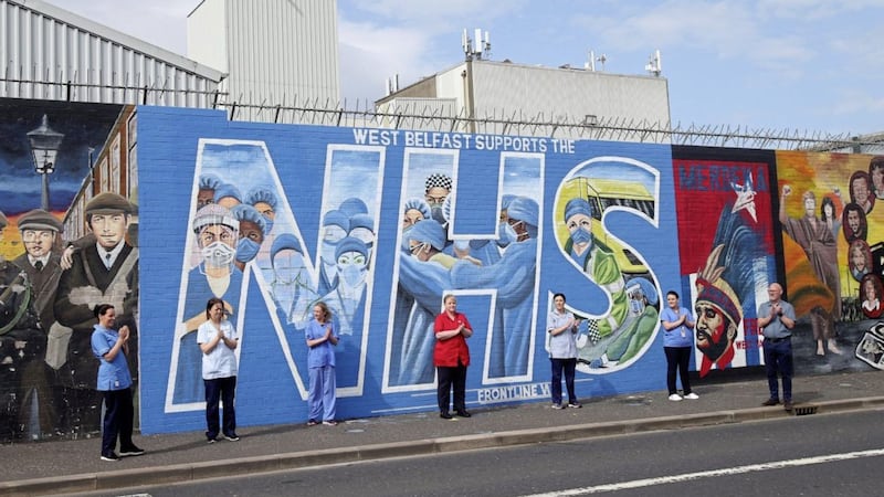 NHS workers gather at a new mural in their honour on the Falls Road in west Belfast. Picture: Mal McCann 