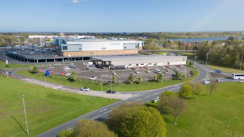 Wide aerial image of a Lidl supermarket next to Rushmere Shopping Centre.