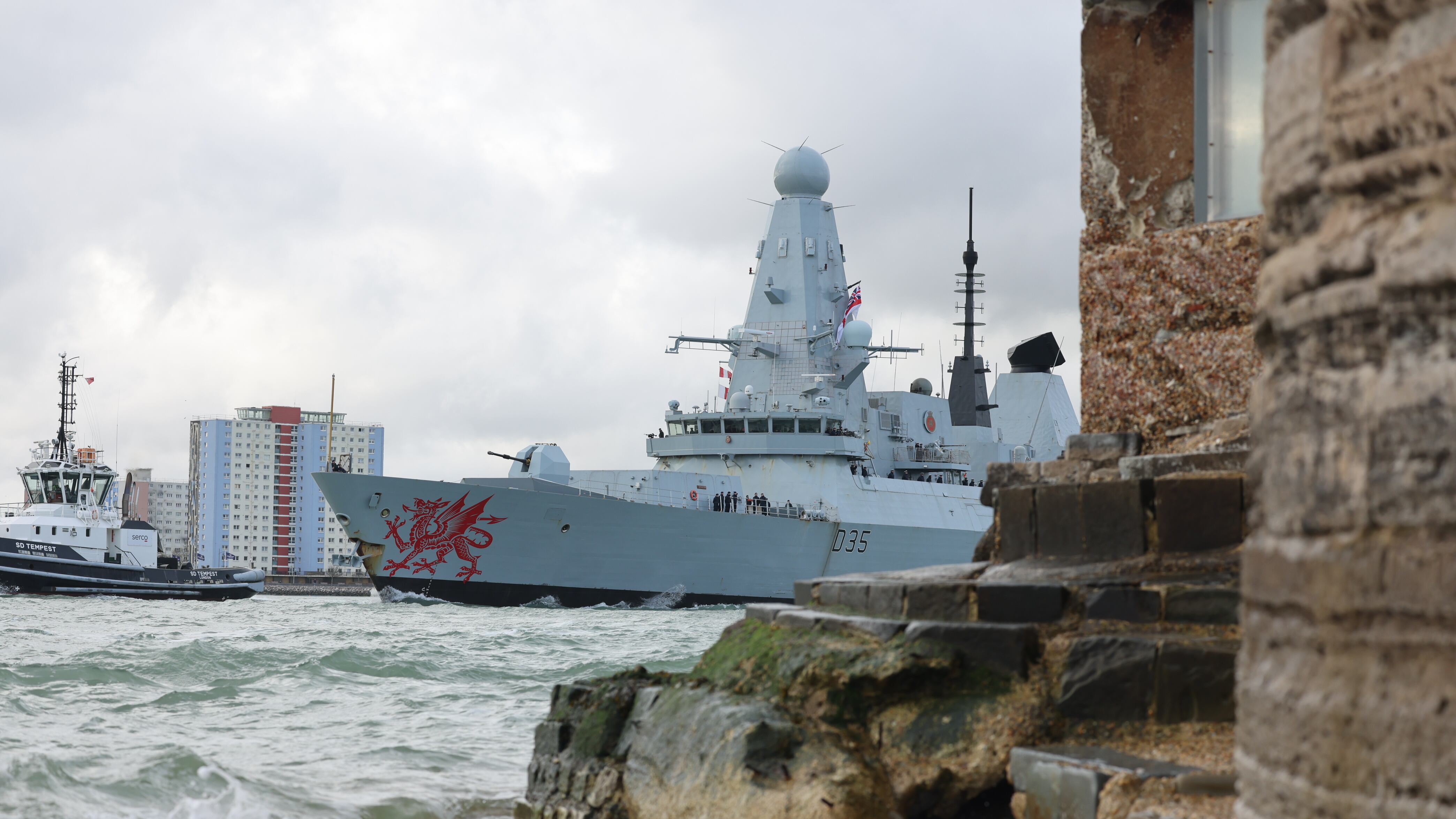 HMS Dragon leaving Portsmouth Harbour on its way to the eastern Mediterranean to bolster British defences in the region