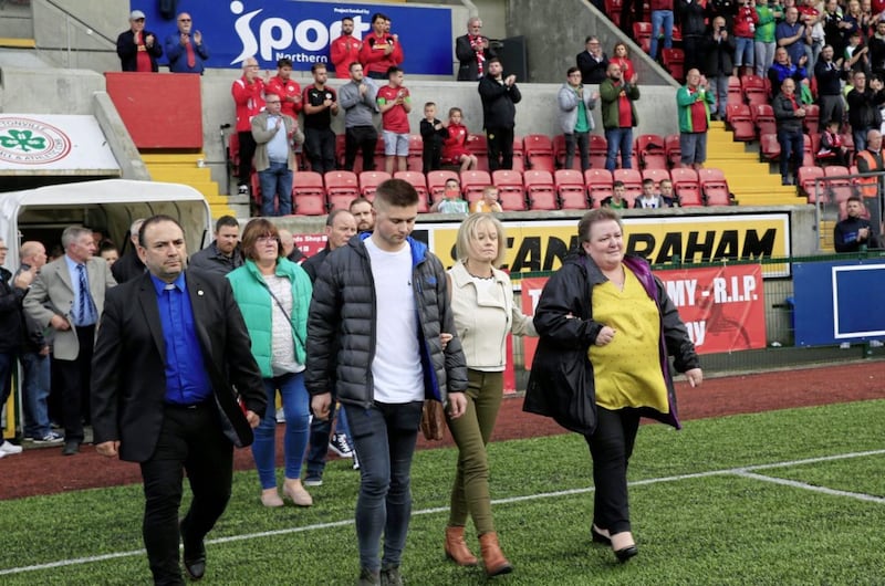 Family members arrive on the pitch to help show a mark of respect for Tommy Breslin. Picture by Philip Walsh 