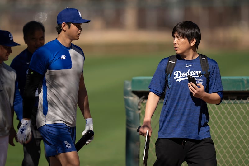 Los Angeles Dodgers’ Shohei Ohtani walks next to interpreter Ippei Mizuhara at batting practice (Carolyn Kaster/AP)
