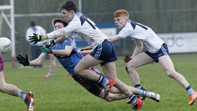 St Michael&#39;s Ryan Flanagan gets the ball away under pressure from St Mary&#39;s Liam Quinn and Adam Connolly. 