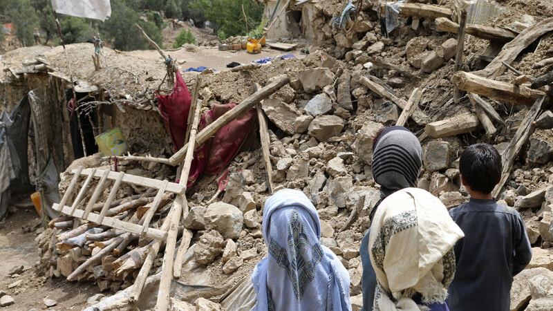 Afghan children stand near a house that was destroyed in an earthquake in the Spera District of the southwestern part of Khost Province, Afghanistan, Wednesday, June 22, 2022 (AP Photo)&nbsp;