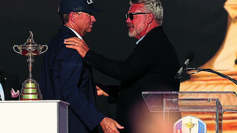 Europe captain Darren Clarke congratulates USA team captain Davis Love III during the closing ceremony on day three of the 41st Ryder Cup at Hazeltine National Golf Club in Chaska, Minnesota last Sunday<br />Picture by AP