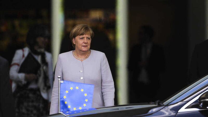 German Chancellor Angela Merkel waits to welcome European Council President Donald Tusk for talks at the chancellery in Berlin on Monday 