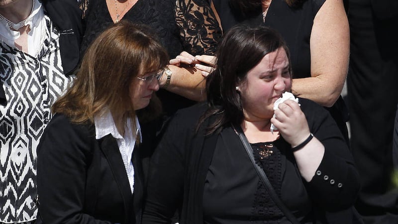 Sinead Hayes, right is comforted at the funeral of her mother and father Larry and Martina Hayes 
