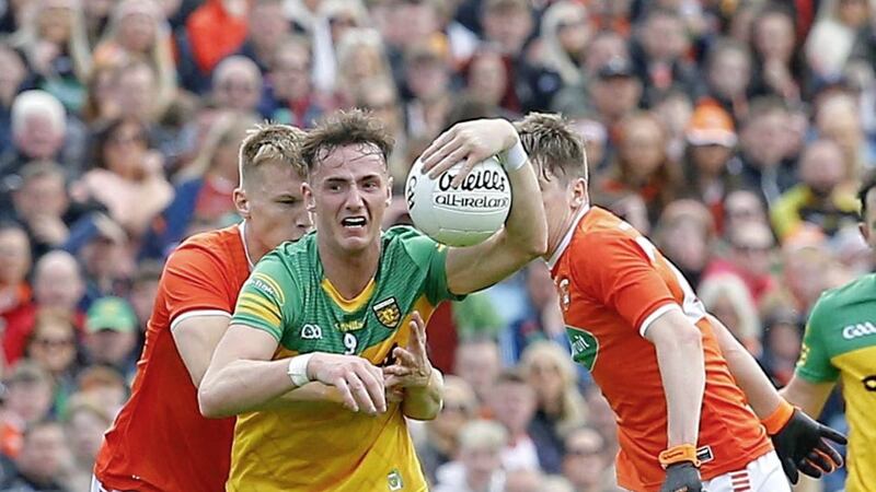 Donegal's Jason McGee tried to get away from Armagh's Rian O'Neill. <br />Pic Philip Walsh