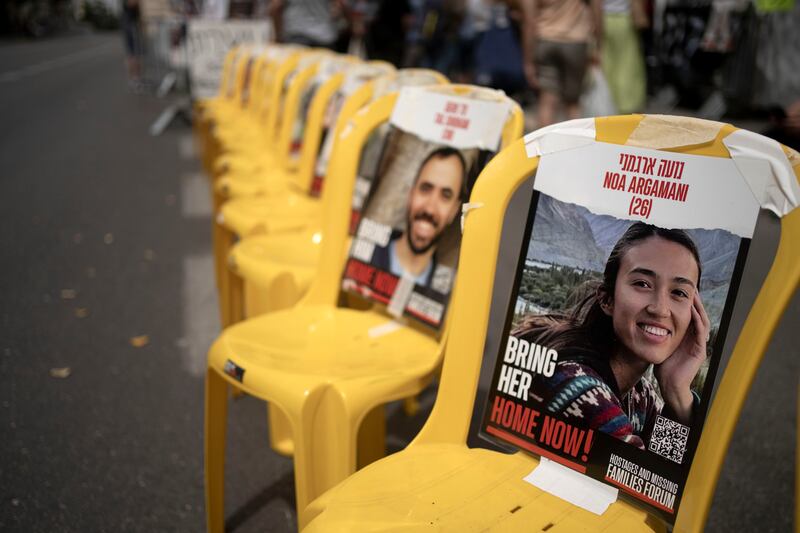 A poster of Noa Argamani is taped to one of the empty chairs for hostages held by Hamas in the Gaza Strip as relatives and their supporters gather together outside Israeli Prime Minister Benjamin Netanyahu’s official residence in Jerusalem (Maya Alleruzzo/AP)