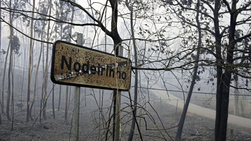 A burnt sign stands at the entrance of the village of Nodeirinho, near Pedrogao Grande, central Portuga Picture: Armando Franca/AP 