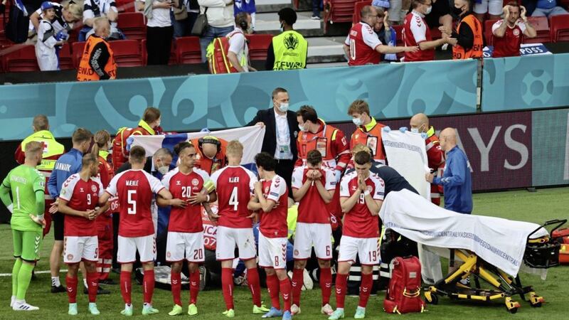 Denmark&#39;s players surround their teammate Christian Eriksen after he collapsed on-field from a cardiac arrest during the country&#39;s game against Finland on Saturday. Eriksen&#39;s life was saved by administration of CPR and a defibrillator. Picture by Wolfgang Rattay/Pool via AP 