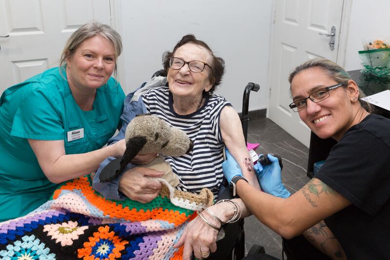 Dorothy France (middle) already has plans on getting another tattoo after having her first tattoo aged 89 (Care UK)