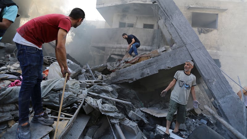 Palestinians look for survivors after Israeli air strikes in Gaza City (Abed Khaled/AP)