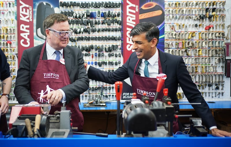 The Prime Minister, right, with Work and Pensions Secretary Mel Stride visiting a Timpson branch after giving his policy speech on welfare reform