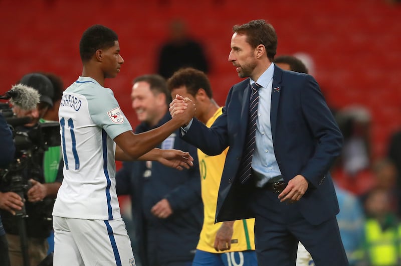 England's Marcus Rashford shakes hands with manager Gareth Southgate