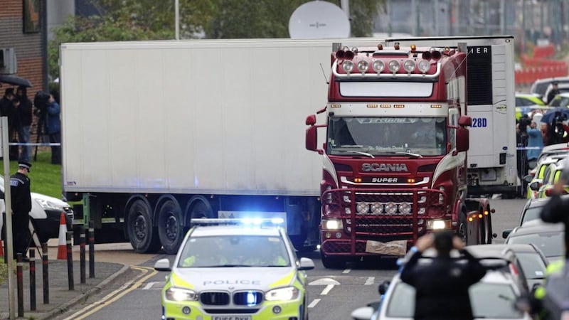 The container lorry in which 39 people were found dead inside as is it driven away by police from Waterglade Industrial Park in Grays, Essex