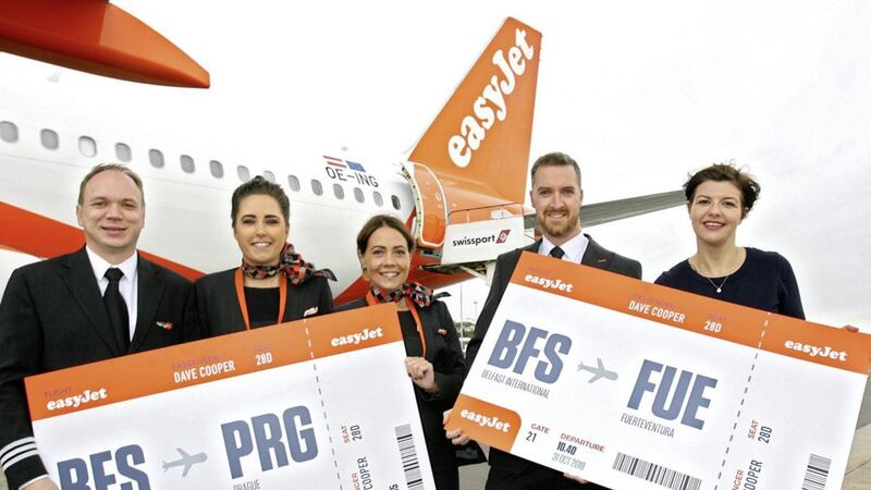 Senior first officer Iain Morrison, cabin crew Natalie Ramsey and Kerry Ferris, captain Paul Heasley and Belfast International Airport marketing manager Deborah Harris celebrate the inaugural flights to Prague and Fuerteventura with easyJet 