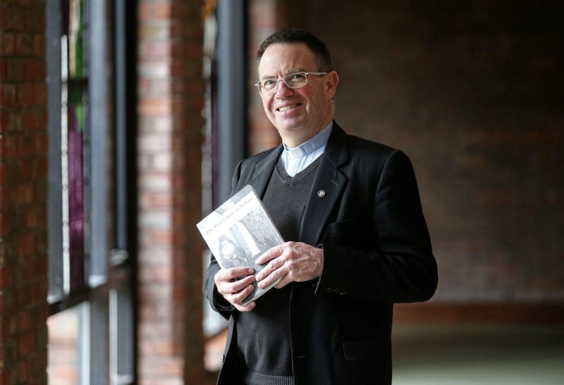 Fr Martin Magill with his new book about the story of the Poor Clares in Belfast. Picture by Mal McCann 