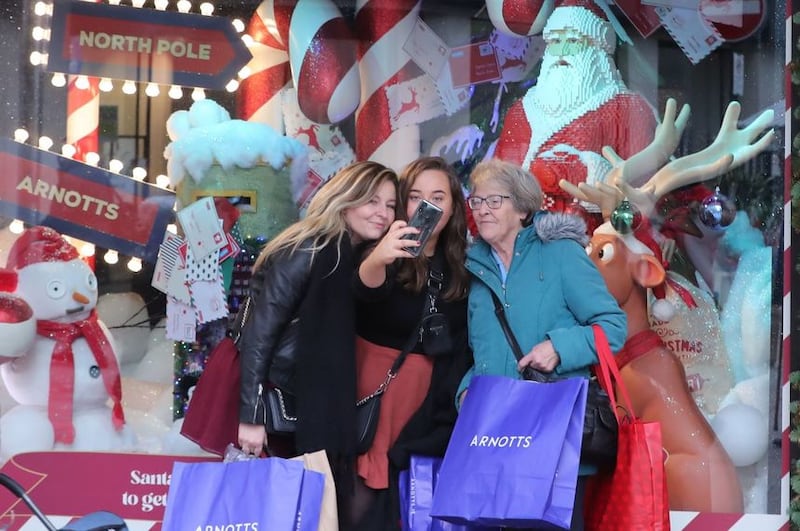 &nbsp;<span style="background-color: rgb(249, 249, 249); color: rgb(76, 74, 80); font-family: &quot;Open Sans&quot;, sans-serif; ">Shoppers take selfies outside Arnotts on Henry street in Dublin city centre, with shops re-opening after six weeks of closure. Ireland is easing out of its second lockdown as non-essential retail stores open across the country.</span>
