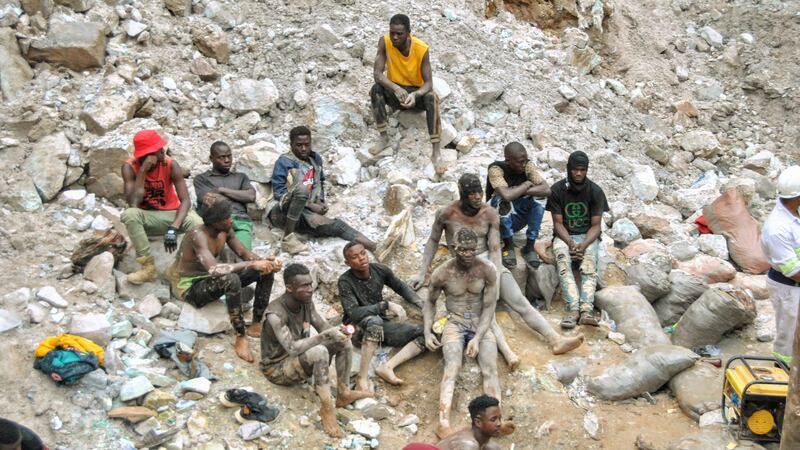 Miners take a break during the mine rescue mission in Chingola (AP Photo)