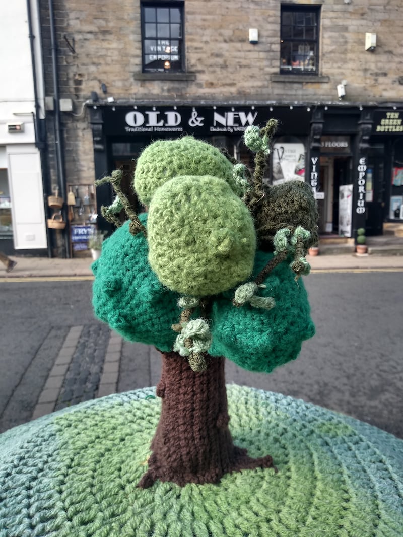 The postbox topper with a green base and a crocheted tree in the centre