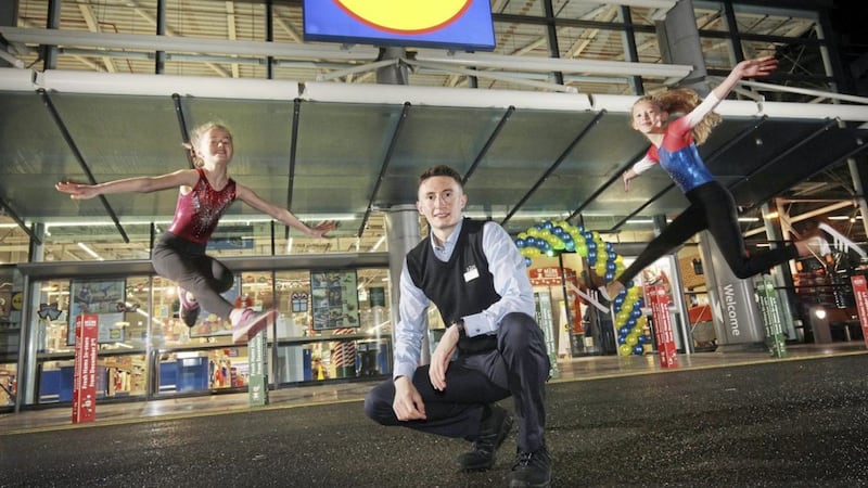 Pictured at the opening of the new Lidl store at Holywood Exchange retail park are manager Eoin Doherty with Sophie Kingston (left) and Isla Parkes from Queens Gymnastics club 