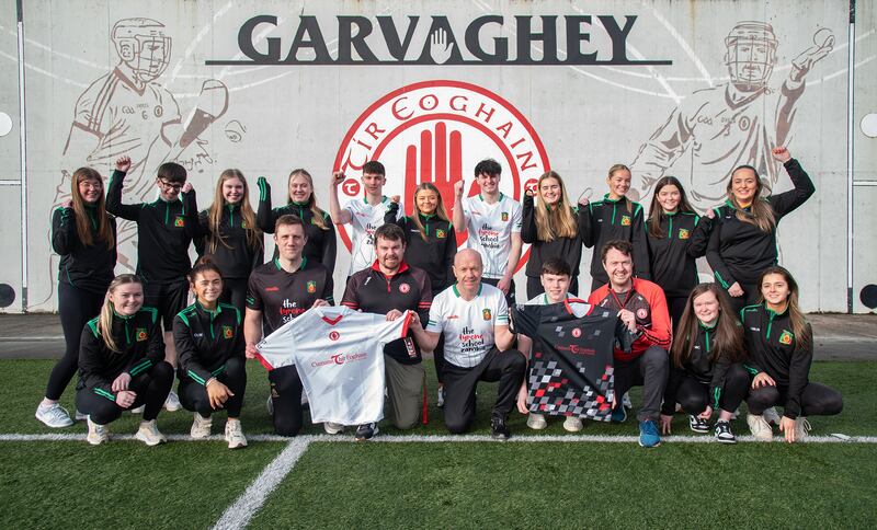 Niall Muldoon and Brian Lavery on behalf of Tyrone GAA presents jerseys to the Holy Trinity College group travelling to Zambia in March. The jerseys will be used by pupils attending the Tyrone School Zambia in Lusaka.