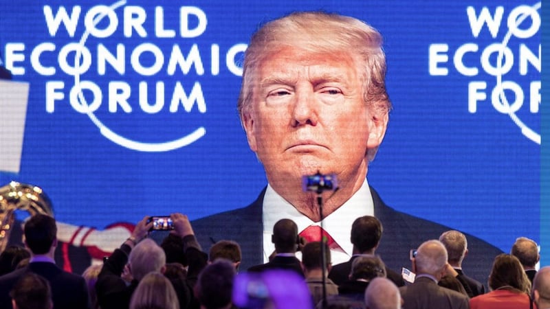 Participants watch the appearance of US president Donald Trump on screen from an adjacent room, during the annual meeting of the World Economic Forum, WEF, in Davos, Switzerland, on Friday. Picture by Gian Ehrenzeller/Keystone via Associated Press 