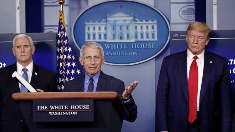 Dr Anthony Fauci with US president Donald Trump and vice president Mike Pence in the White House press briefing room earlier this year. Picture by Alex Brandon/AP 