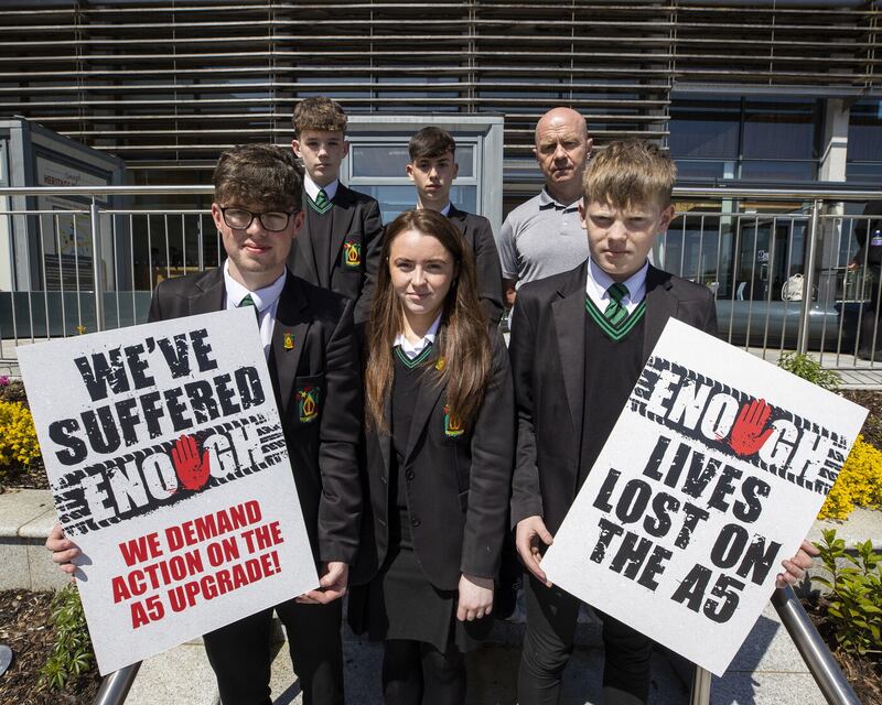 Peter Canavan (back right), director of sport at Holy Trinity College Cookstown standing with students at Strule Arts Centre in Omagh where a public inquiry is being held examining the proposals for a new dual carriageway along the route of the A5. Picture by Liam McBurney/PA Wire