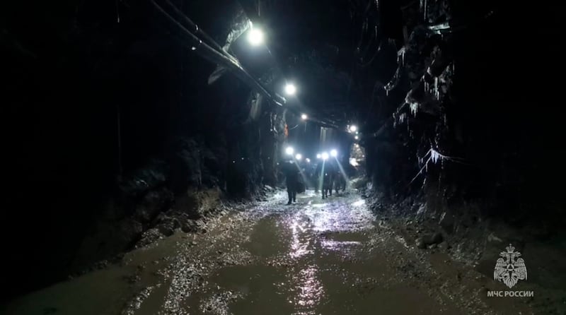 Rescuers walk inside the gold mine (Russia Emergency Situations Ministry press service via AP)