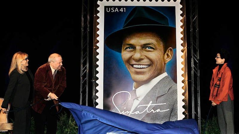 In this Wednesday, Dec. 12, 2007 file photo, Frank Sinatra's children, from left, Nancy Sinatra, Frank Jr., and Tina, unveil a 10-ft. image of the Frank Sinatra commemorative postal stamp that will be issued by the United States Postal Service, during a ceremony commemorating Sinatra's 92nd birthday, in Beverly Hills, Calif.&nbsp;