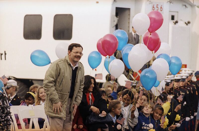 Mr Anderson and his daughter Sulome, not shown, and her mother, Madeleine Bassil, arrive at Dulles International Airport in 1991 (AP)