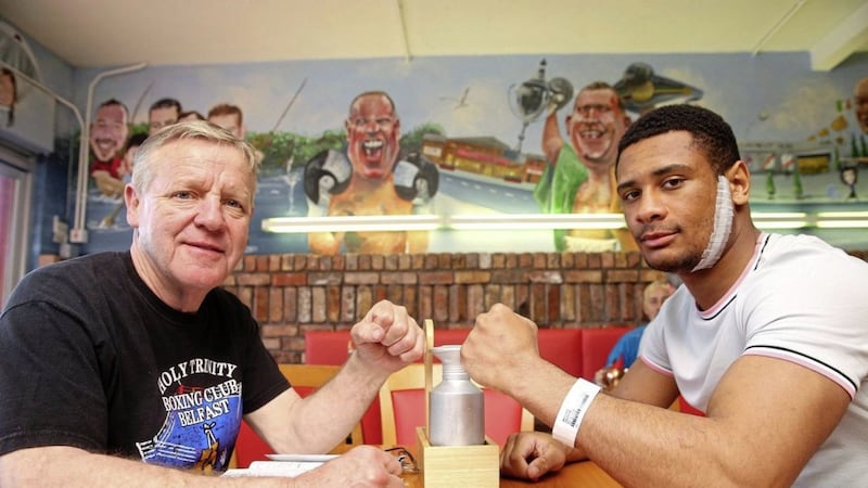 Belfast boxer Caoimhin Hynes, right, with his coach Michael Hawkins at Kelstar cafe on Andersonstown Road after being released from hospital. Picture by Mal McCann 