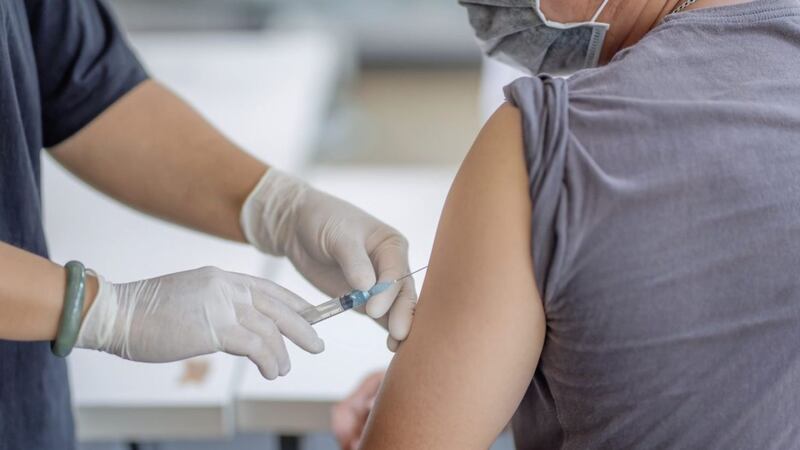 The doctor is injecting male patients.In the medical&#39;s hand have syringes.. 