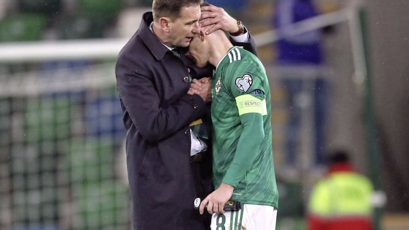 Northern Ireland manager Ian Baraclough consoles captain Steven Davis after the 2-1 defeat to Slovakia in the Euro play-off final. 