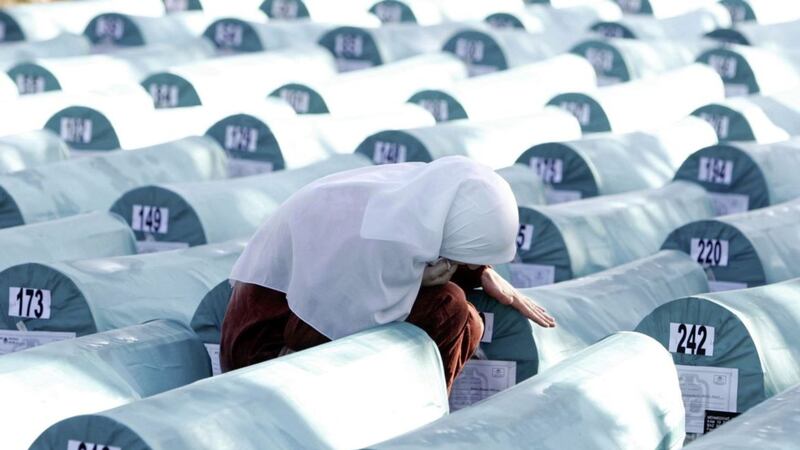 A Bosnian Muslim woman weeps among coffins of Srebrenica genocide victims during a funeral ceremony on Friday July 11 2008. The 307 bodies were excavated from mass graves in eastern Bosnia and were identified as Muslims killed by Bosnian Serb forces in the Srebrenica area. More than 8,000 Bosnian Muslim men and boys were killed after Srebrenica fell on July 11 1995.