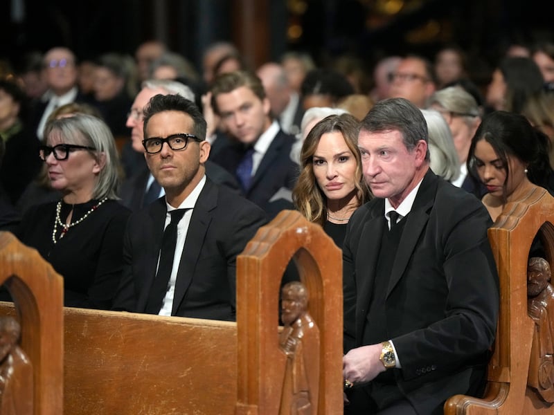 Actor Ryan Reynolds, second from left, and former NHL player Wayne Gretzky, right (Ryan Remiorz/The Canadian Press/AP)