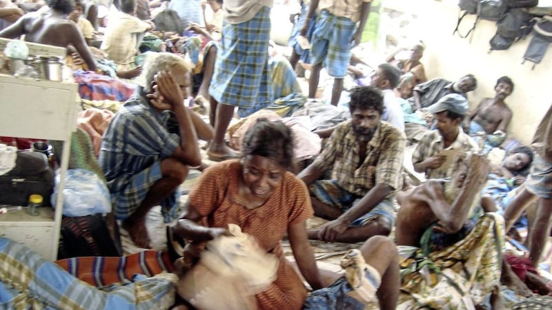 Internally displaced Sri Lankan ethnic Tamil civilians wait at a makeshift hospital in Mullivaikal Sri Lanka in 2009 