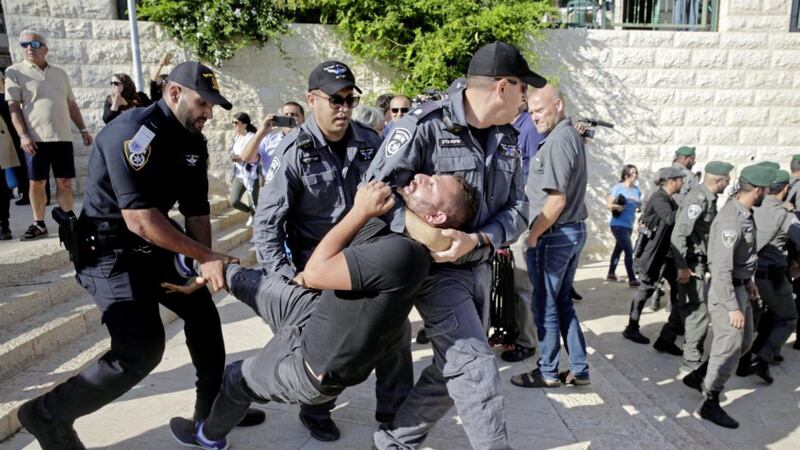 Israeli police officers detain a demonstrator during a protest outside the US embassy in Jerusalem. Picture by Mahmoud Illean, Associated Press 