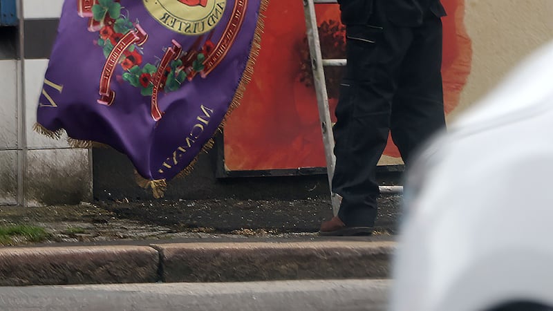 Shankill Butcher Eddie McIlwaine erecting flags in Glenwood Street off the Shankil Road NO BYLINE