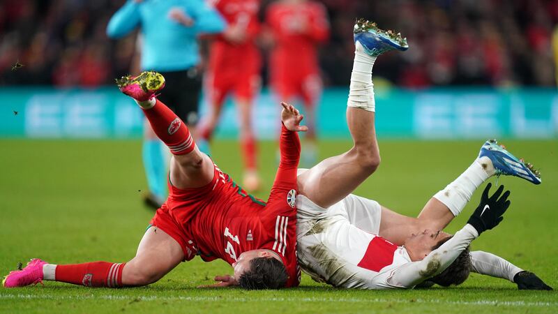 Connor Roberts, left, collides with Kenan Yildiz during Wales’ 1-1 draw with Turkey (David Davies/PA)