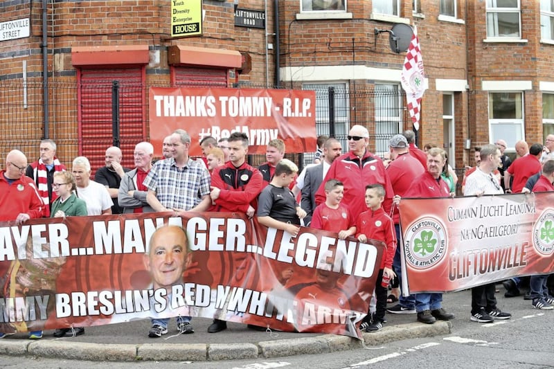 A large group of fans await the funeral cortege of Tommy Breslin as it passes the clubs football ground in north Belfast Picture Mal McCann. 